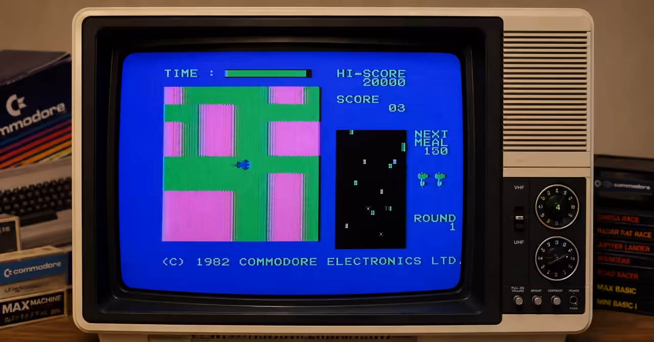A Commodore MAX game displayed on a vintage 1980s colour CRT television, illustrating the machine's colourful VIC-II graphics and arcade-style gameplay.