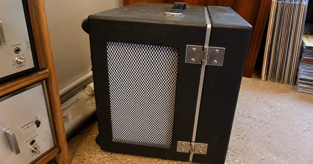 Detachable speaker cabinet for the AKAI 1710 reel-to-reel recorder, showing the silver metal grille, hinged side panel and textured black carrying case.